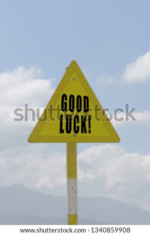 Traffic signs: Good luck word with cloudy blue sky on background.