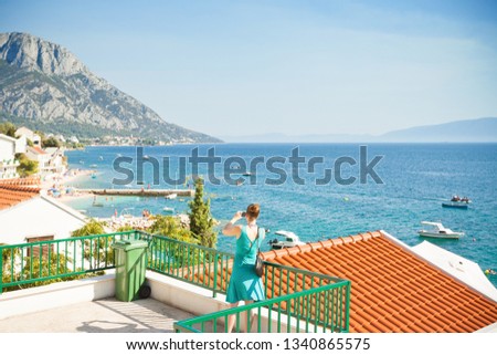 Brist, Dalmatia, Croatia, Europe - A woman taking a picture of the beautiful bay of Brist