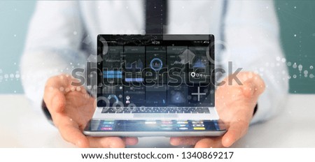 View of Businessman holding Laptop with business user interface data on the screen isolated on a background