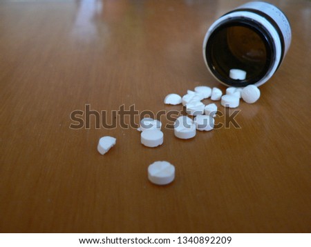 
white medication tablets in vial
