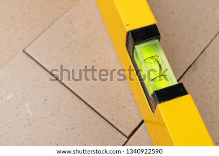 Measuring the slope of a surface using a spirit level. Measuring accessories for mechanics. Dark background.