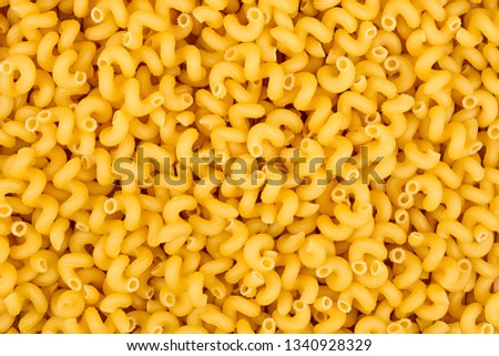texture of raw Cavatappi Cellentani noodles pasta italian food macro close-up background Royalty-Free Stock Photo #1340928329