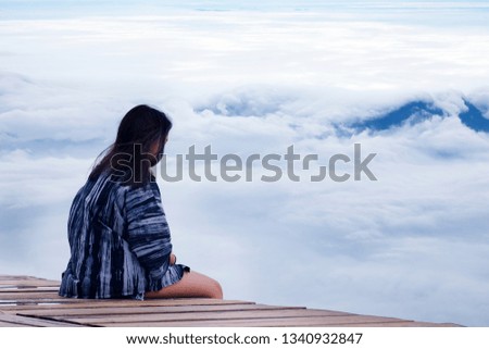 young asian teen sitting alone on clouds