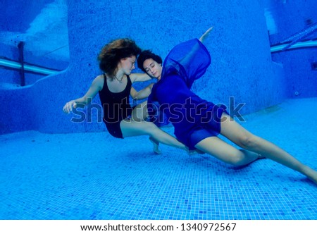 Underwater models with dress in the pool