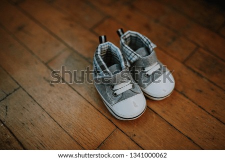 Top view baby shoes on wooden background floor
