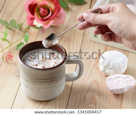 cocoa with sweets on wooden background