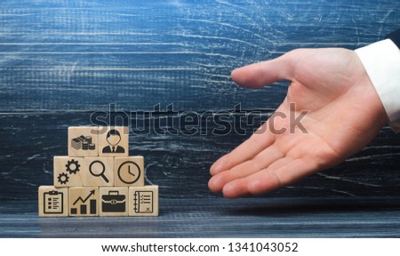 The hand of a businessman presents a recipe from business elements and attributes for a successful business. The correct construction and structure of the business, good leadership and innovation Royalty-Free Stock Photo #1341043052
