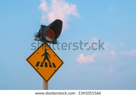 Pedestrian lane symbol and a traffic light.