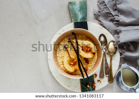 Breakfast oatmeal bowl and baked pears with maple syrup, vanilla and almond on white background flat lay. Recipe and idea healthy breakfast - Image