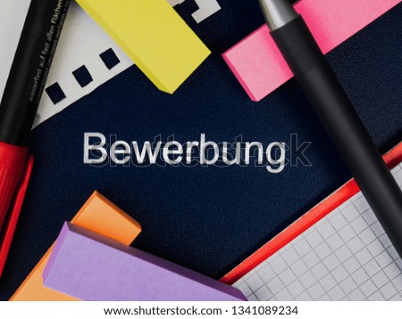 Folder with the german word "Bewerbung" on it, which means application in english. Top view. Closeup.