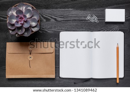A black desk with stationery supplies