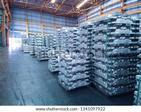 Aluminium ingot bundles stored inside industrial warehouse. Industry raw material logistics operation. Royalty-Free Stock Photo #1341097922