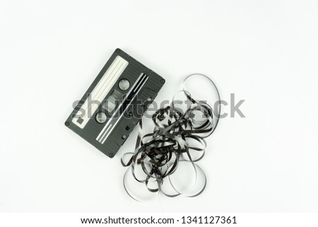 This shows a well known problem with the old fashioned compact cassettes: the tape used to come out, making the cassette useless Royalty-Free Stock Photo #1341127361