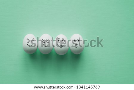Painted Eggs with cute hand drawn funny faces. Happy easter card concept.