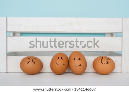 
Brown eggs with cute hand drawn funny faces.