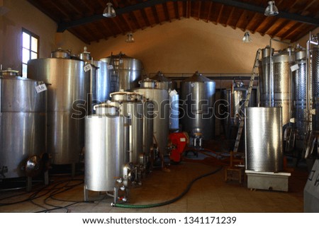 Old winery interior with barrels and bottles. Production process of wine.