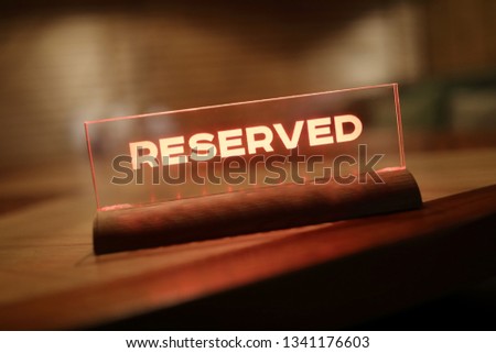 Glowing Sign Reserved in restaurant at nigt