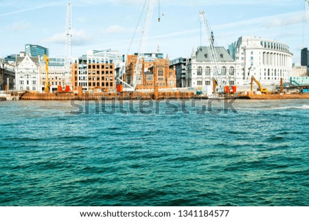 Colourful vivid image of River Thames bank side - building new and maintain old architecture - blue sky in London