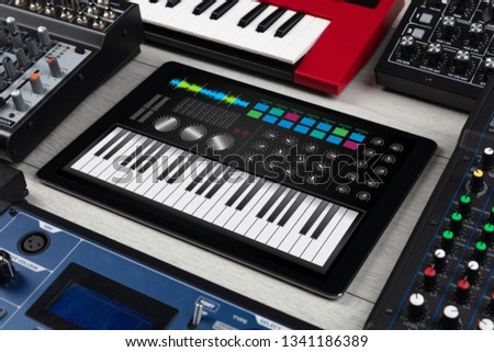 Piano synthesizer app on tablet and musical instrument concept