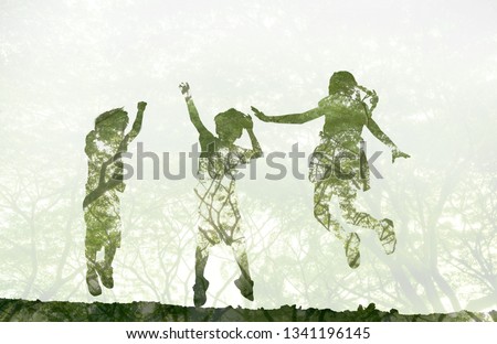 world environment day concept.Double exposure kids jumping and playing on meadow and nature background Royalty-Free Stock Photo #1341196145