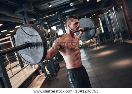 Young strong man during training in the gym