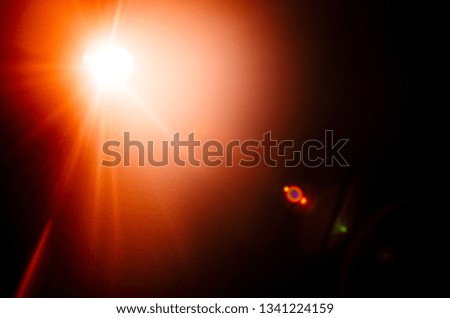 Abstract Natural Sun flare or Far star on the black background - image
