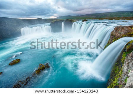 Godafoss is a very beautiful Icelandic waterfall. It is located on the North of the island not far from the lake Myvatn and the Ring Road. This photo is taken after the midnight sunset Royalty-Free Stock Photo #134123243