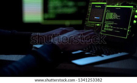 Cybercriminal creating malicious software, typing on laptop keypad, closeup Royalty-Free Stock Photo #1341253382
