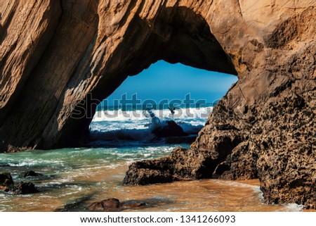 Santa Cruz Beach portugal with rocks and large waves in the beach