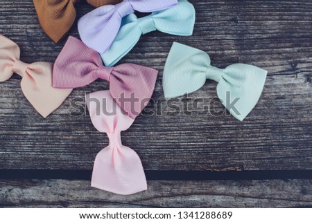 Colorful head accessories, pastel ribbon bows on dark background