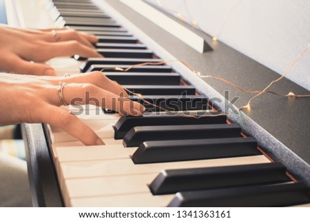 International jazz day. Piano keyboard background.  female hands playing piano