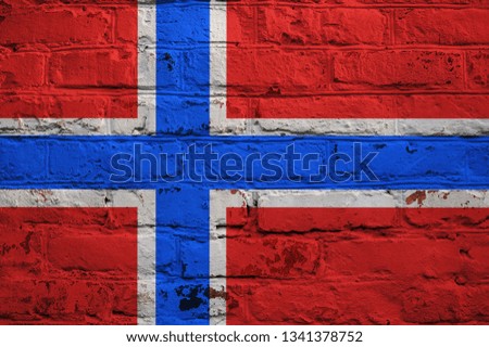 Norwegian flag on brick wall background.