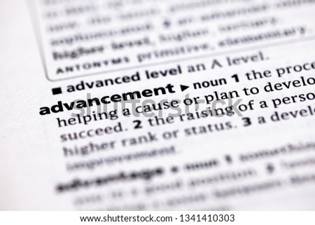 Blurred close up to the partial dictionary definition of Advancement