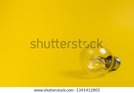 Light bulb on Yellow Solid Background with Copy space for Editor's text.