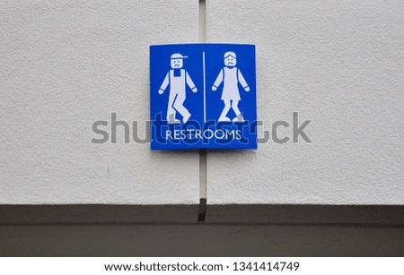 Restrooms sign above the entrance of the hallway