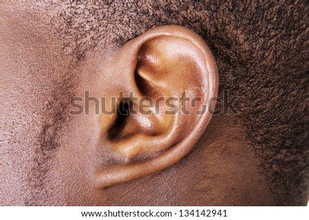 Black male ear close up Royalty-Free Stock Photo #134142941