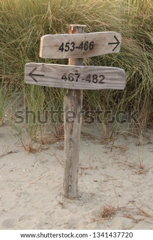 wooden sign in the dunes
