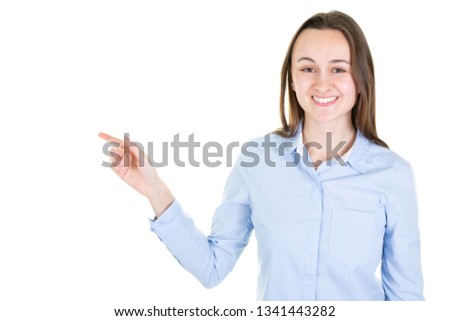 cute young woman pointing at copyspace looks in camera