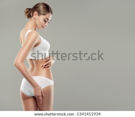  Perfect slim toned young body of the girl . An example of sports , fitness or plastic surgery and aesthetic cosmetology. Royalty-Free Stock Photo #1341451934