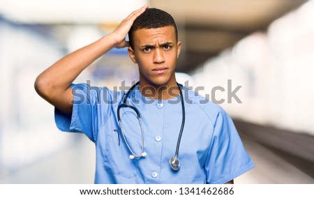 Surgeon doctor man with an expression of frustration and not understanding in a hospital