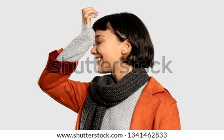 Short hair woman with coat has realized something and intending the solution on isolated grey background
