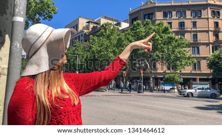 Happy woman with straw hat visiting city in spring.