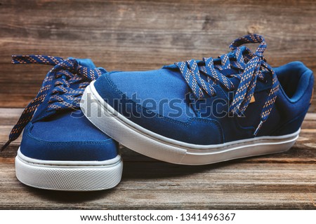 Stylish sports shoes on a wooden background.