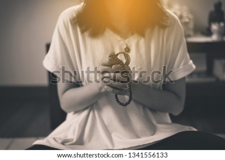 Woman prayer hands with beads cross the hands,Women with in praying position,Black and white toned