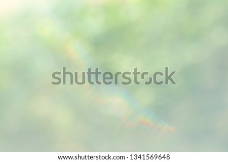 Defocused abstract nature background with green leaves and bokeh lights. Royalty high-quality free stock image of natural blurred bokeh background from leaf and tree