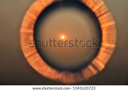 tropical morning sun on blurry brown round abstract frame as background