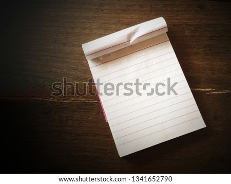 Blank notepad on wood table 