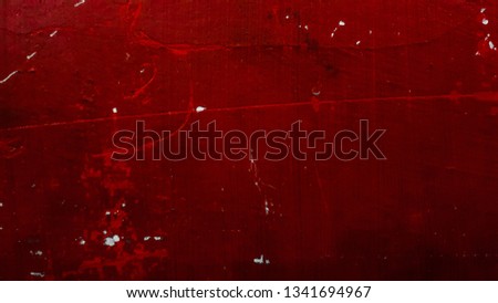 Wall texture with peeling paint background. Dark red color.