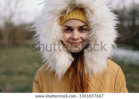  cute woman in the hood smiling nature portrait                              