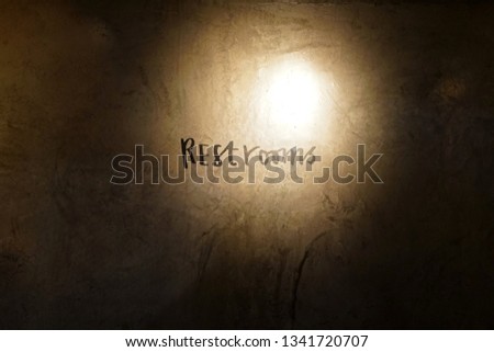 Restrooms text with lighting on concrete cement loft wall